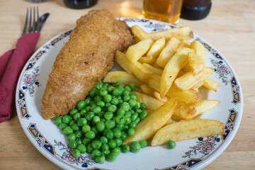 Fish and chips with peas on plate Cotswolds England