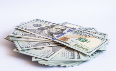 Pile of 100 dollar banknotes on white background