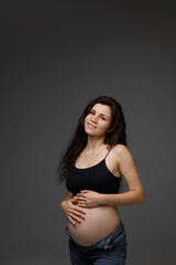 pregnant woman in studio on grey background