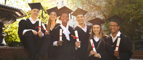 Graduation. Portrait of joyful group of multiracial students who together received diploma of...