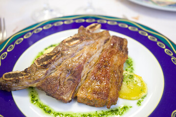 Beef churrasco with garlic and parsley sauce on blue plate Spain