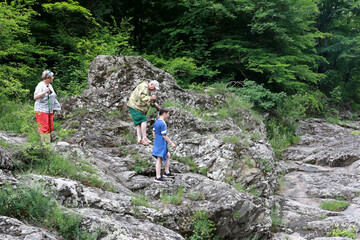 Naklejka na ściany i meble Family on bank of Belaya river in granite gorge