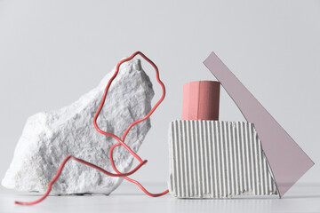 Horizontal close-up studio shot of contemporary still life composition of various objects made of different materials, white background