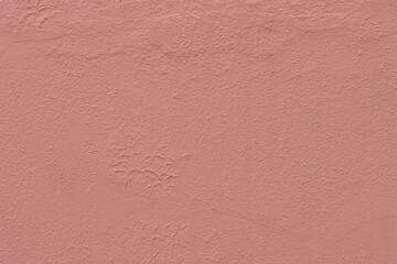 Abstract background of red rough grungy plaster on the wall