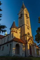 Fototapeta premium Church in Ceske Budejovice city with big tower in autumn evening