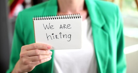 Text we are hiring on notepad in person hand