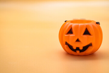 close-up plastic halloween pumpkin on orange background