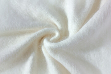 Swirl Background texture of white pattern knitted fabric made of angora and wool close up.