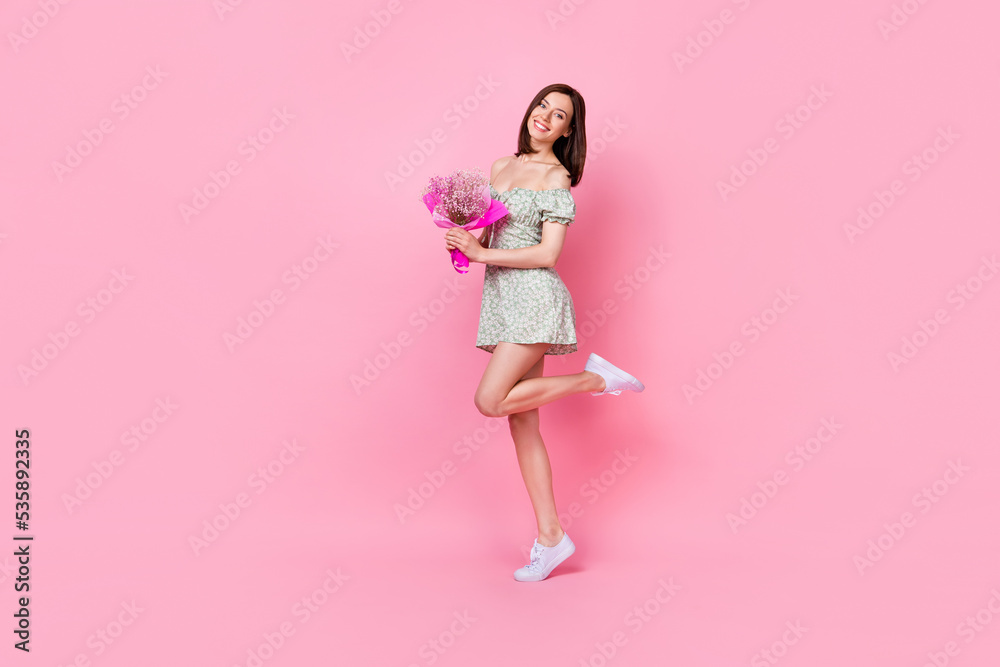 Sticker full length photo of gorgeous lovely pretty positive lady raise leg hold flowers rejoice present gif