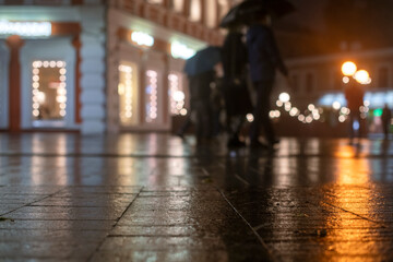 Night urban landscape, colored lights reflected in the wet asphalt in fall. Rainy night street in the city.
The lights of a rainy night in the autumn city of disfocus and bokeh.