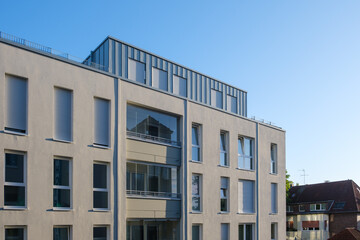 Fototapeta premium Facade of a modern apartment building against a blue sky