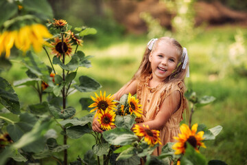 girl with a sunflower, summer in the village, August, vegetable garden