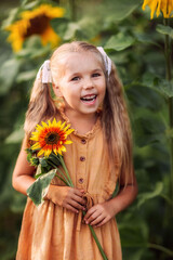 girl with a sunflower, summer in the village, August, vegetable garden