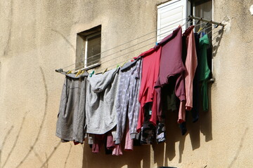 Washed clothes and linen dries on the balcony.
