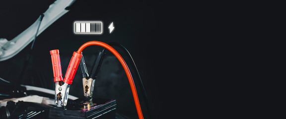 Battery charging of the car and a glow charging icon , panoramic banner copy space on black...