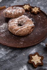 Homemade craft gingerbread cookies sprinkled with powdered sugar on a gray background