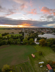 Fototapeta na wymiar Beautiful aerial vertical panorama of a little village in Sweden, stormy weather and sunset, rural landscape