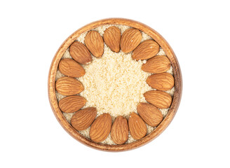 Almond flour and almond grains in a wooden bowl on a white background.