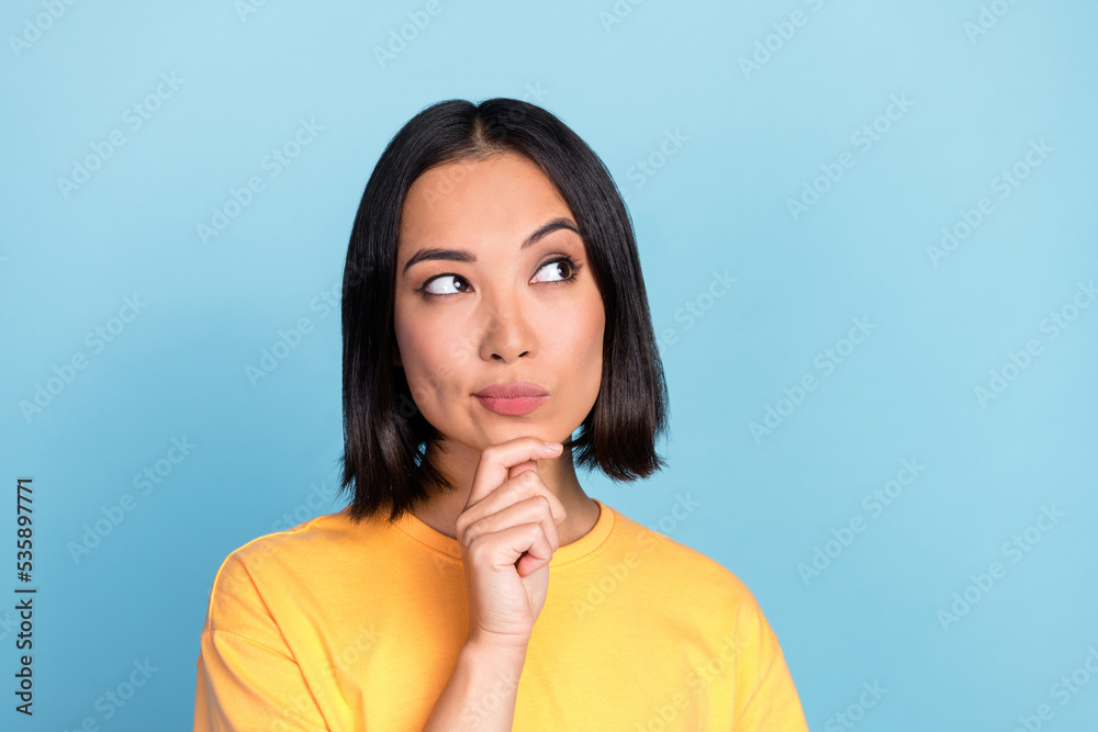 Sticker Closeup photo of young attractive gorgeous nice girl touch chin unsure look empty space touch chin offer ad isolated on blue color background