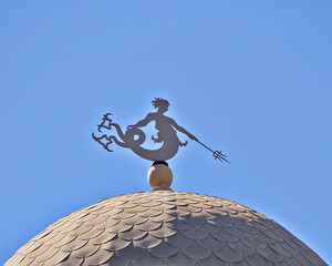 Classic design building dome with Triton ancient Greek deity as wind vane. Space for your text in...