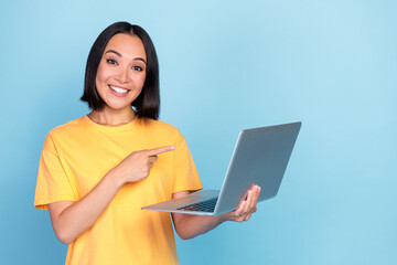 Photo of nice lovely cheerful girl with bob hairstyle wear yellow t-shirt directing laptop good discount isolated on blue color background
