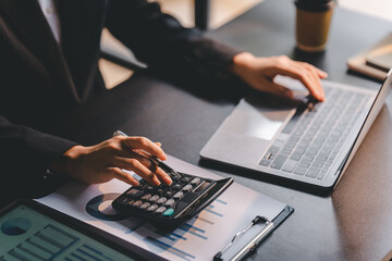 Portrait of a woman working on a tablet computer in a modern office. Make an account analysis...
