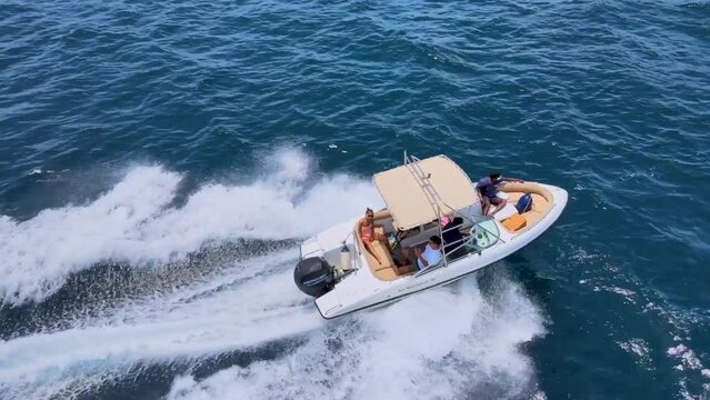 aerial view speed boat cruising in ocean travelling on beautiful blue sea sailing to holiday destination in mediterranean from above