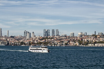 Fototapeta premium View of a cruise tour boat on Bosphorus and European side of Istanbul. It is a sunny summer day.