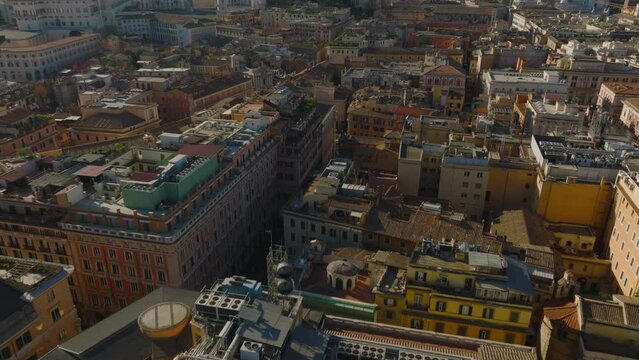 Aerial slide and pan footage of buildings in urban borough. Majestic Vittoriano monument with statues of goddess Victoria riding on quadrigas. Rome, Italy
