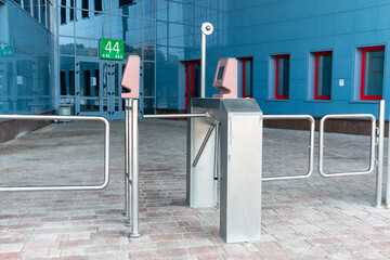 Turnstile in front of the entrance to the building. The turnstile is designed to restrict the passage of people when it is necessary to check the right of entry and exit of each person.