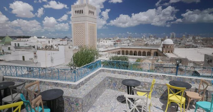 Panoramic view of colorful tiled terrace overlooking the medina, with a view on the minaret of Ez Zitouna Mosque (Great Mosque). Tunis, Tunsia.