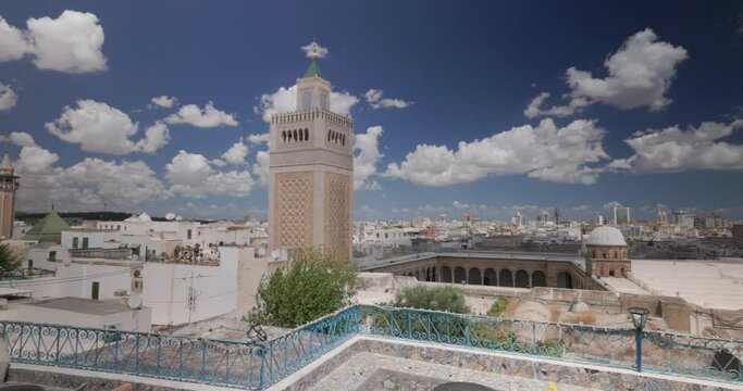 Panoramic view of city of Tunis from a colorful tiled terrace , with a view on the minaret of Ez Zitouna Mosque (Great Mosque) and the minaret of Hammouda Pacha Mosque. Tunisia.