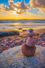 Stone tower on the beach with evening sunset light