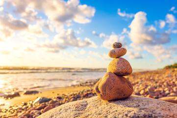 Stone tower on the beach with evening sunset light