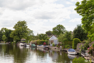 Fototapeta na wymiar Pleasure boats and tea houses along the river Vecht near the Dutch village of Loenen aan de Vecht.