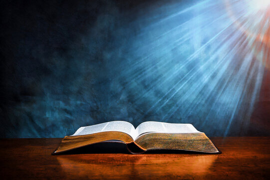 Open old book on wooden table, BIBLE