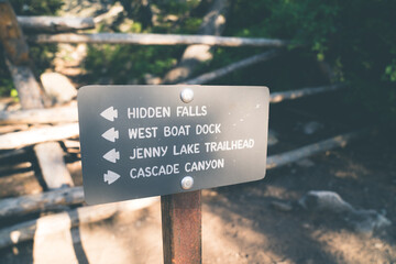 Trail directional marker for hikers in Grand Teton National Park - showing Hidden Falls, West Boat Dock, and Cascade Canyon