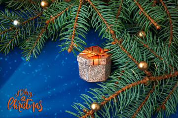Christmas tree branches, balls, hearts, gift on a blue background