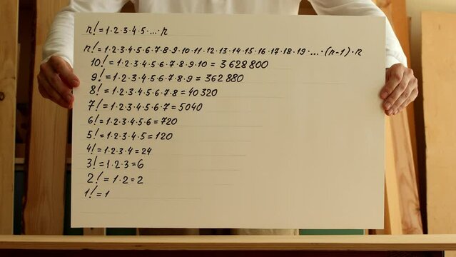Mathematician shows paper with a factorial numbers. Reverse playback video. Pavel, my hands and paper. Date of shooting day 13 July 2022 year, MSK time. This video was filmed in Russia.