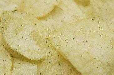 Potato chips on a rotating surface. Close-up.