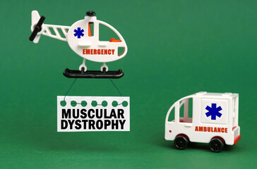 On a green surface, an ambulance car and a helicopter with a sign - MUSCULAR DYSTROPHY