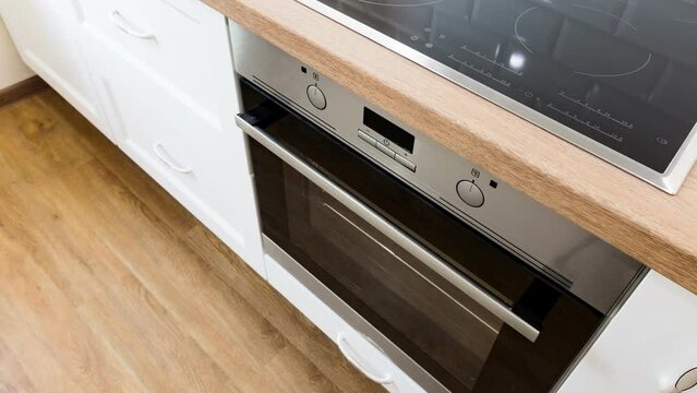 White kitchen with wooden countertop with induction cooktop. Nobody