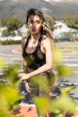 Fototapeta na wymiar female model wearing sportswear, beauty and fashion of young woman with long hair moving in the wind, fitness lifestyle in park
