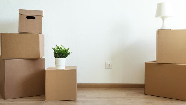 Packed household boxes for movement in empty room. Movement concept