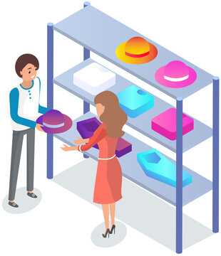 Choosing clothes in store with consultant. Shop assistant helps buyer to choose product during shopping. Customer service in mall. People stand near hangers with clothes in store or boutique