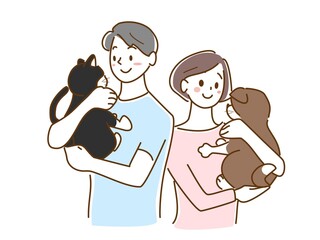 猫と犬を抱きかかえる男女