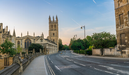 High street panorama at dawn with Magdalen bell tower in Oxford. England