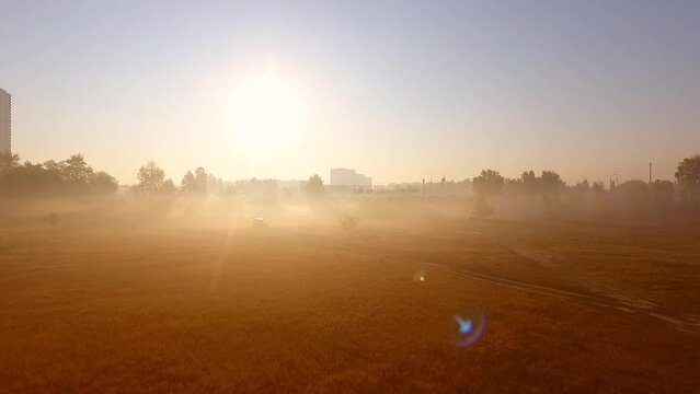 the silhouette of the city above the fog in the golden sunlight troeschina
