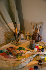 the artist's desk. Brushes. Mixed colors on the palette. 