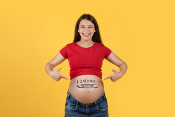 Obraz premium Cheerful Pregnant Woman Pointing At Loading Mark On Belly